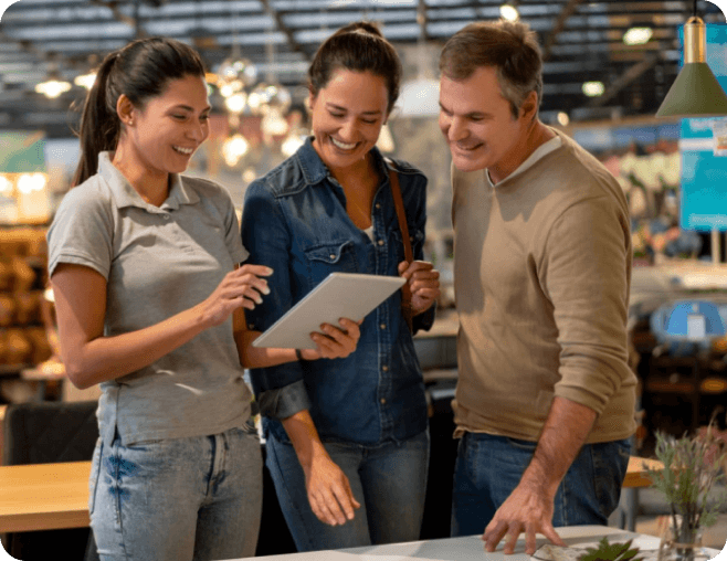 three people looking at a tablet