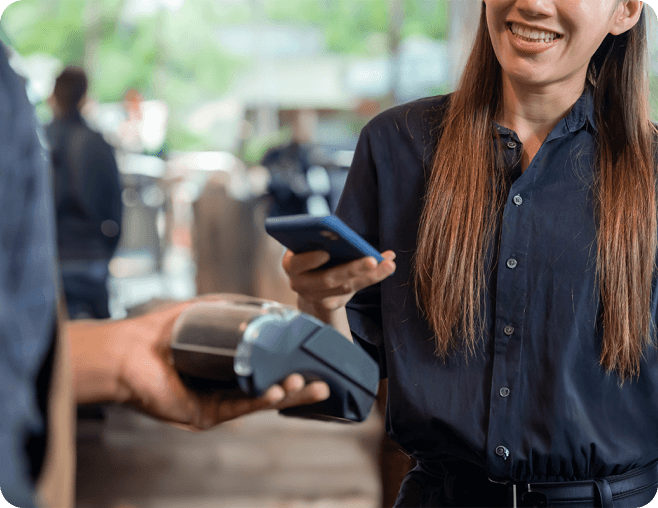 women using phone to pay