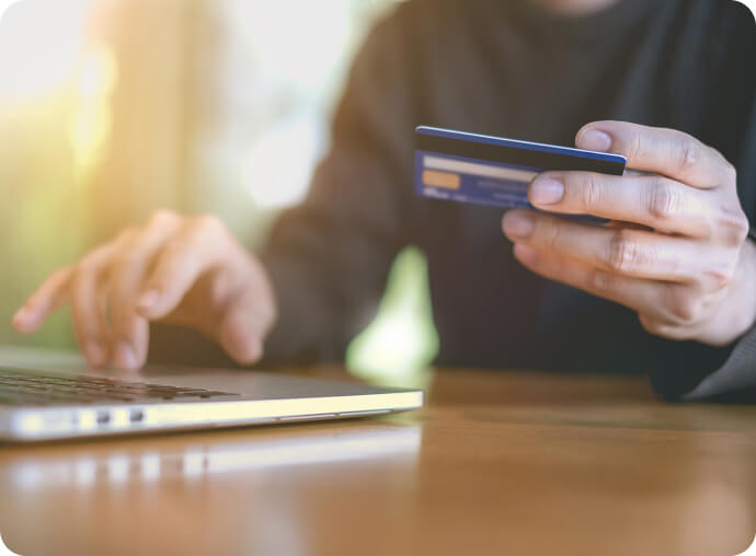person entering credit card info into computer