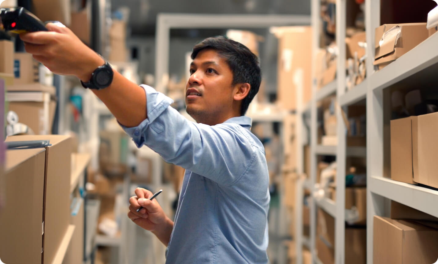 man in stock room grabbing product