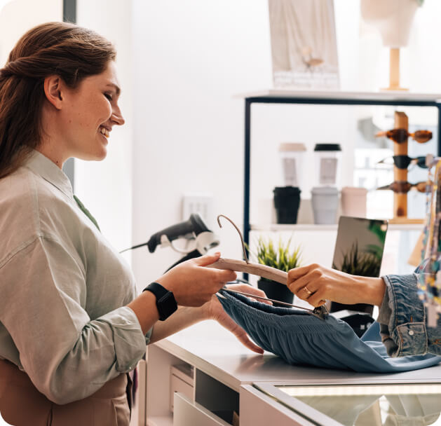 women at register in retail store