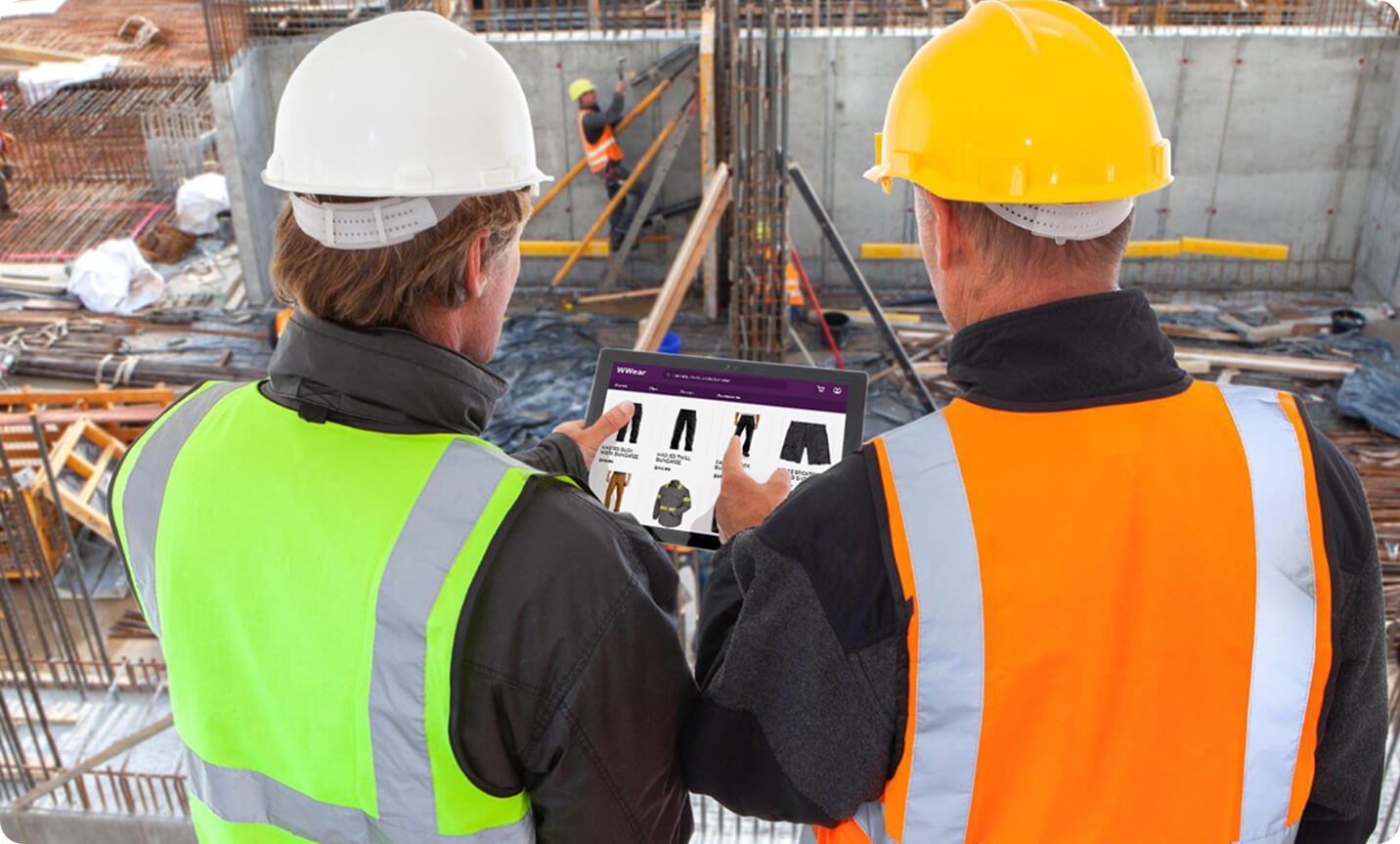 two construction workers looking at a tablet